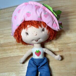 Vintage Strawberry Shortcake Freckled Rag Doll in jeans and pink bonnet.